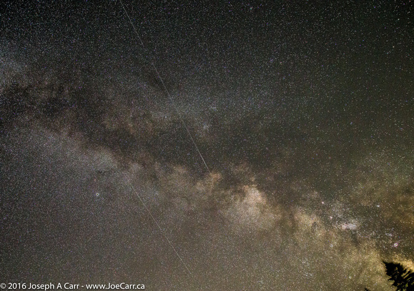 Two satellites streaking across the Milky Way