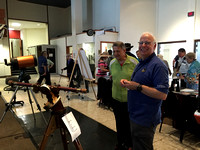 Chris and a visitor admiring the Galileo telescope replica