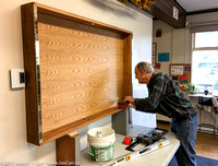 Terry attaching the cabinet to the wall
