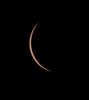 Very thin crescent shaped partially eclipsed Sun before Totality