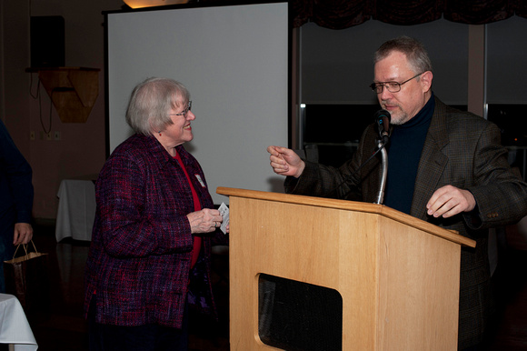 Betty Hesser accepts her door  prize from Steve Pacholuk