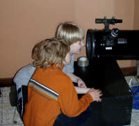 Young astronomers checking out some telescope optics