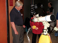 Bill Almond showing a boy the view of the Moon through a telescope