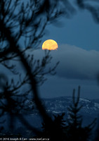 The setting Full Moon over the Highlands