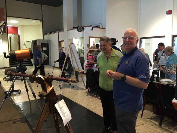 Chris and a visitor admiring the Galileo telescope replica