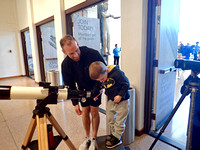 A young astronomer tries out a telescope