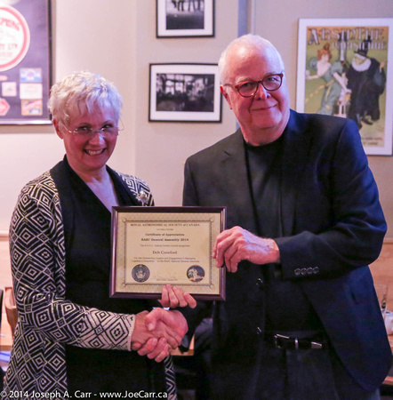 Deb Crawford is presented with a Certificate of Appreciation by
