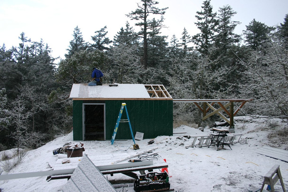 Charles completes the roof sheeting in the snow
