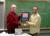 Charles Banville receives the Excellence in Astrophotography Award from John McDonald for his 2009 photo 'Moon Over Mt Baker'