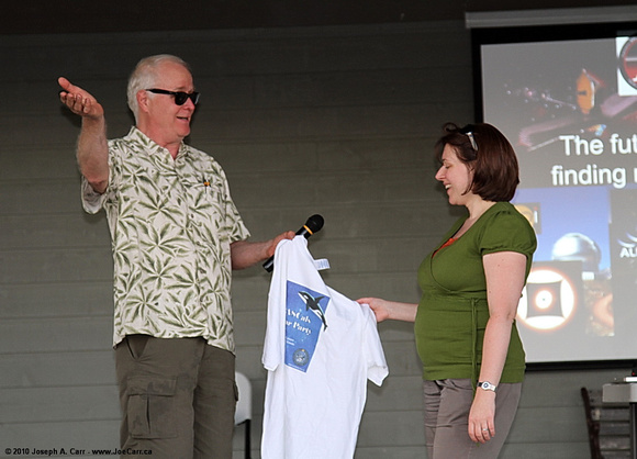 Dr. Brenda Matthews being presented with a souvenier t-shirt by Nelson Walker