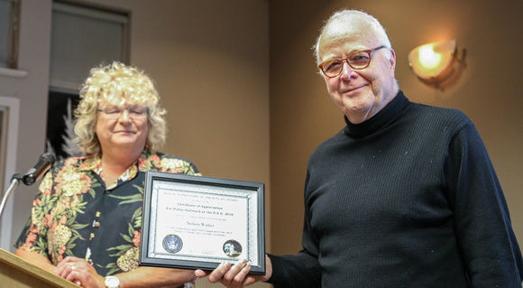 Nelson Walker receives his Certificate of Appreciation for public outreach at the DAO from Sherry Buttnor