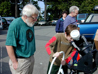 Ed Maxfield shows a young astronomer the partial Solar Eclipse